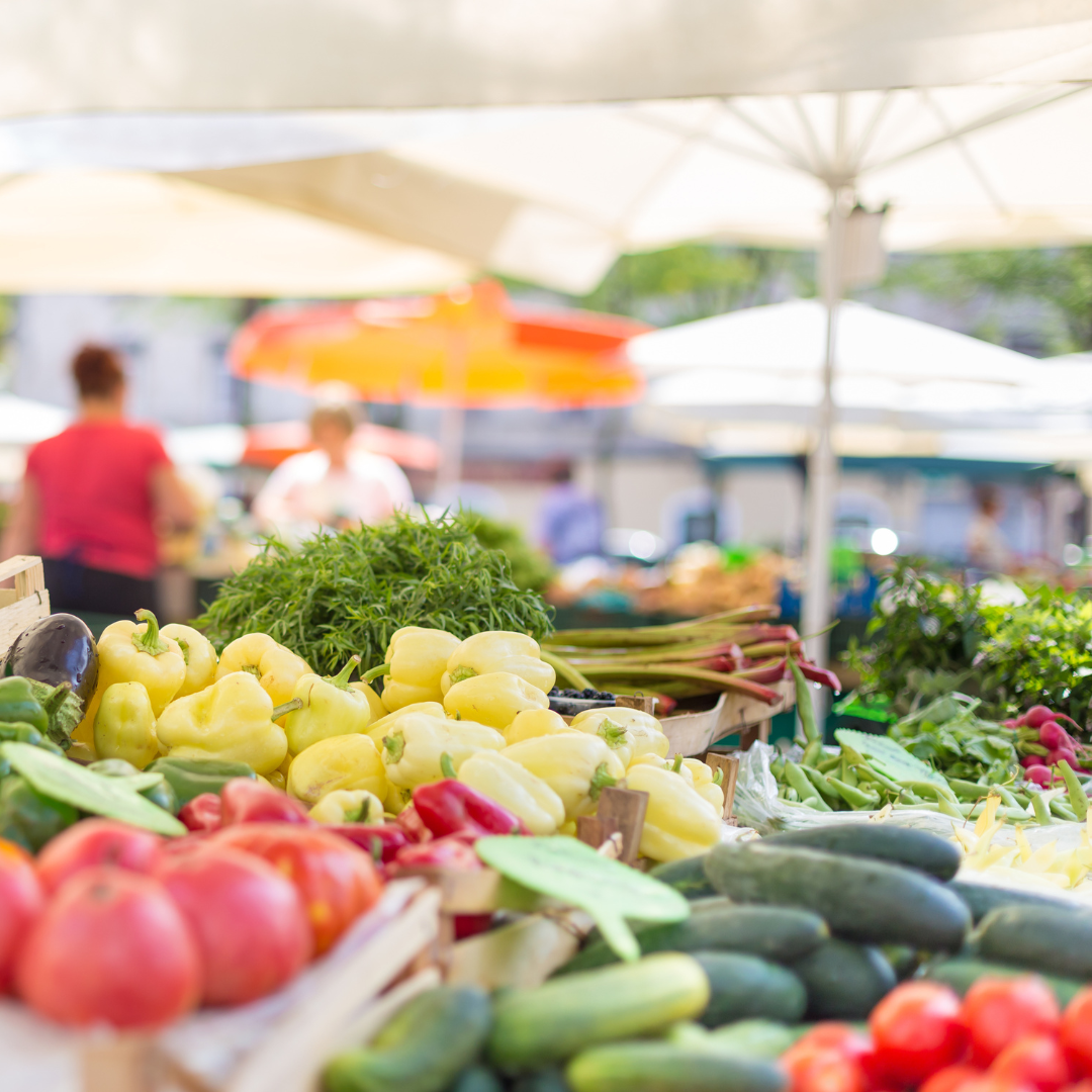 photo of farmers market stand showcasing fresh fruits and vegetables